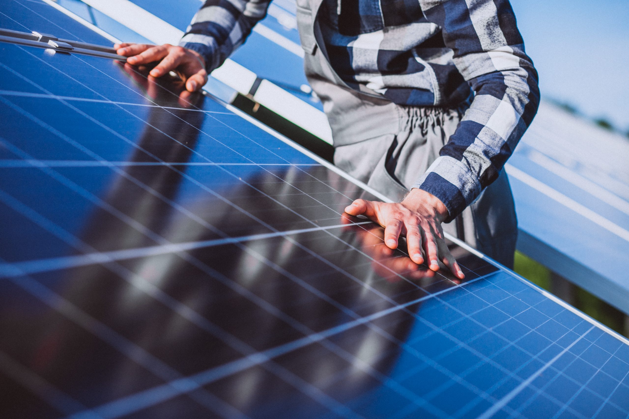 man worker firld by solar panels